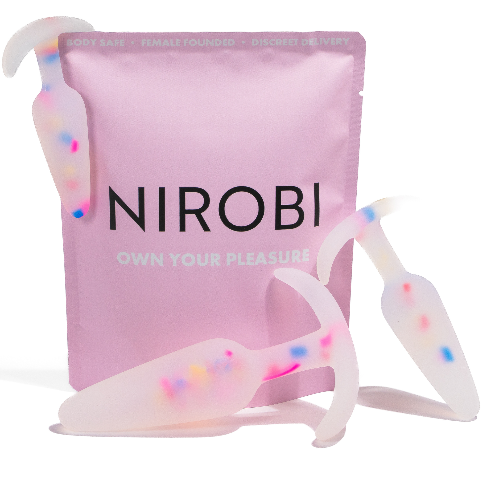 Three translucent silicone butt plug trainers with colourful confetti flecks displayed beside a pink Nirobi pouch.