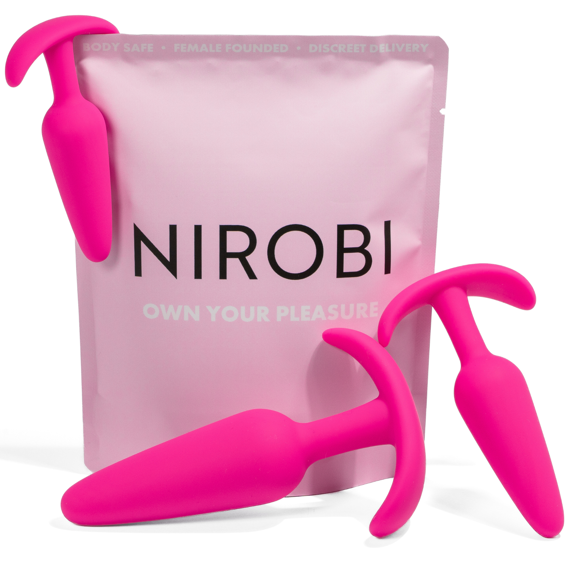Three bright pink silicone butt plug trainers in graduated sizes arranged in front of a pink Nirobi pouch.