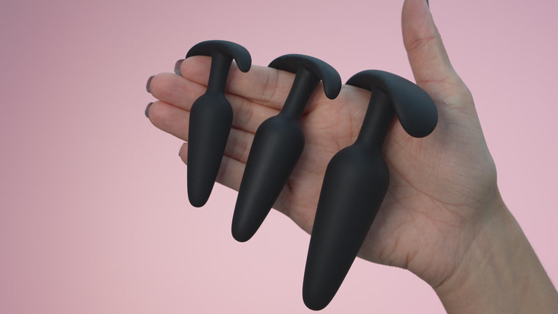 butt plugs for anal training for female and males in black, pink, purple and confetti. 